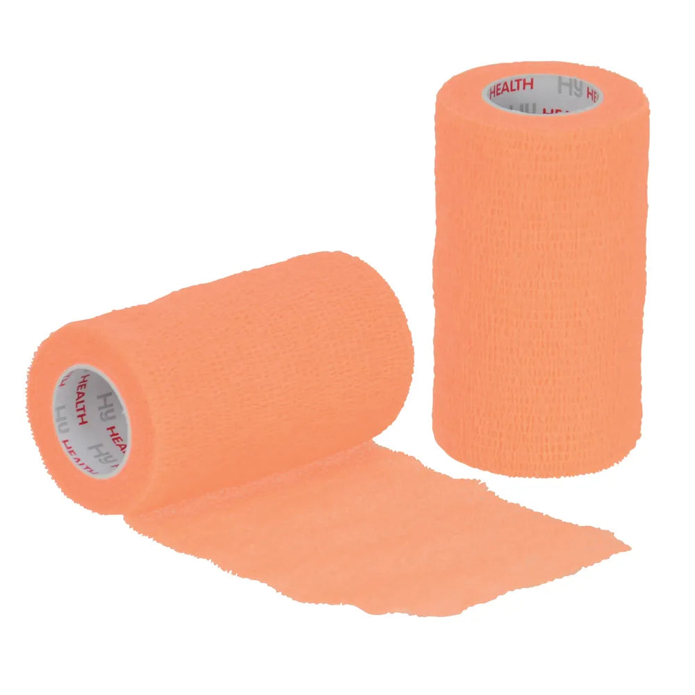 Two rolls of orange cohesive bandage on a white background
