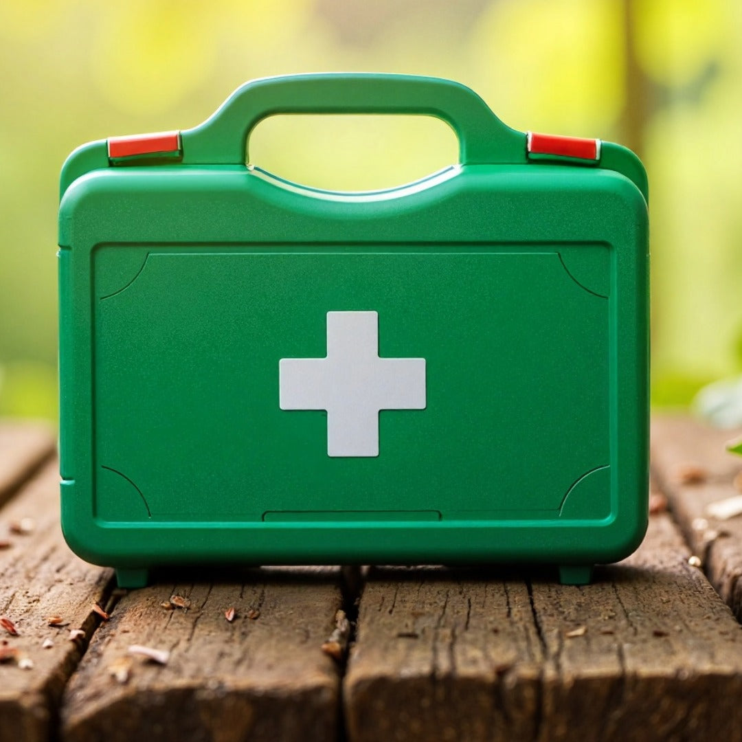 Green first aid kit with a white cross on a wooden surface