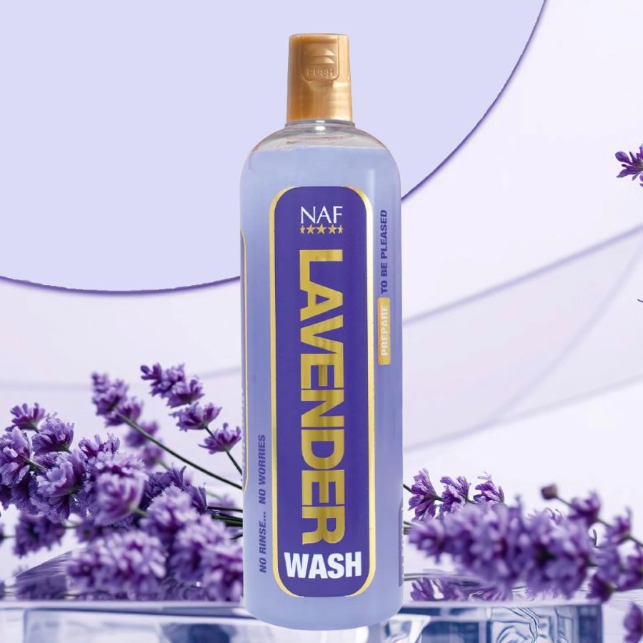 A bottle of NAF Lavender Wash for horses with lavender flowers in the background