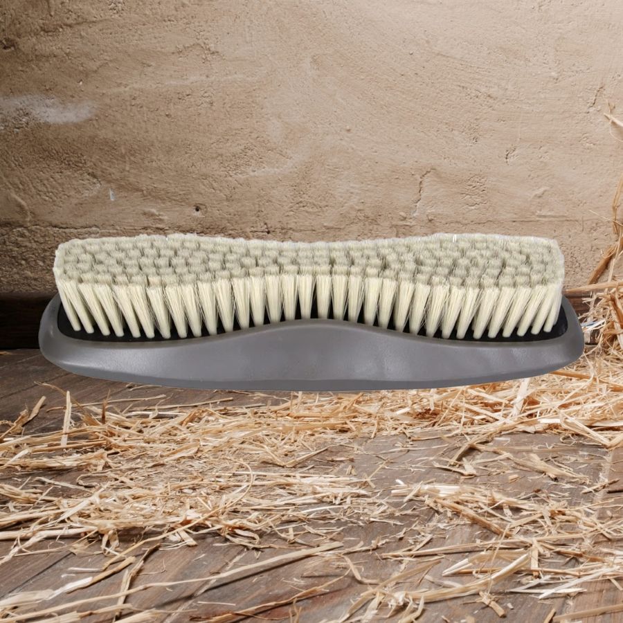 Wahl Horse brush with soft bristles on a wooden surface with straw