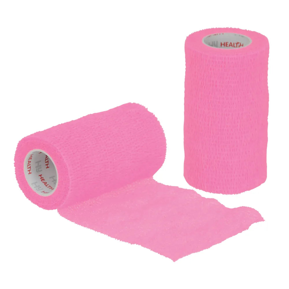 Two rolls of pink cohesive bandage on a white background