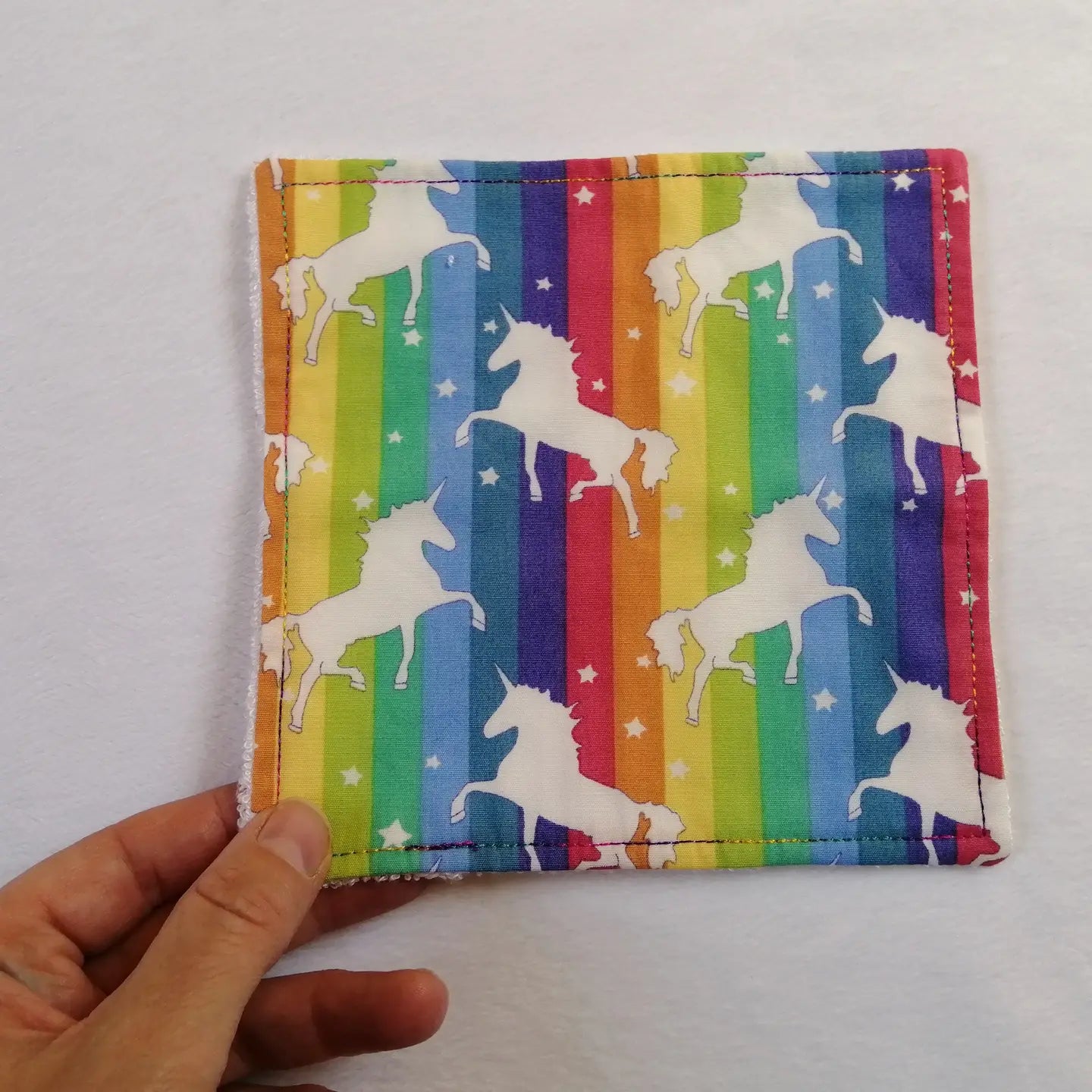 Reusable bamboo cloth with rainbow design featuring white unicorns.