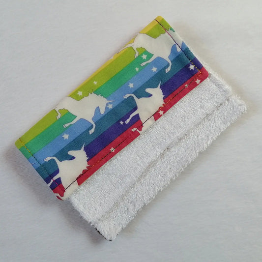 Rainbow striped bamboo cloth with unicorn pattern on a white background