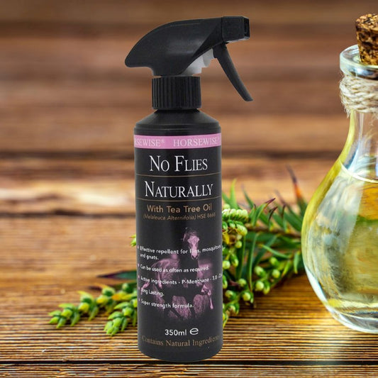 Horsewise No Flies Naturally spray bottle with tea tree oil on a wooden surface