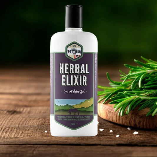 Bottle of Thomas Pettifer 'Herbal Elixir' skin gel for horses on a wooden surface with greenery.