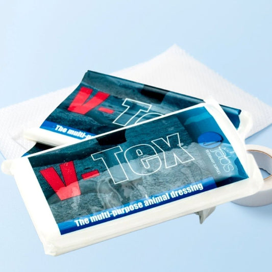 V-Tex animal dressing packages on a white tray with a light blue background