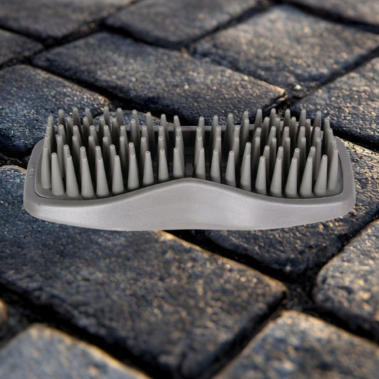 Wahl rubber curry comb for horses on a stone cobble floor