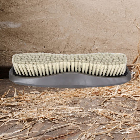 Wahl Horse brush with soft bristles on a wooden surface with straw