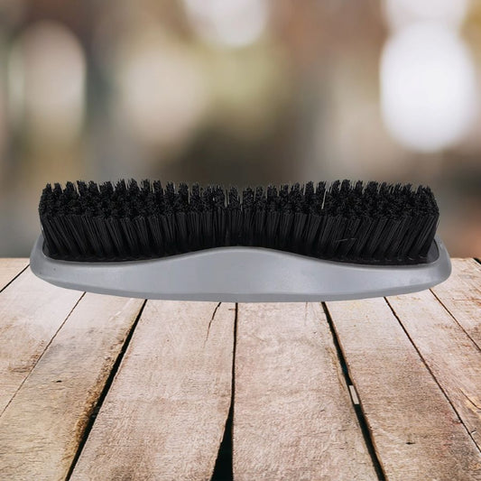 Wahl stiff body brush with black bristles on a wooden surface